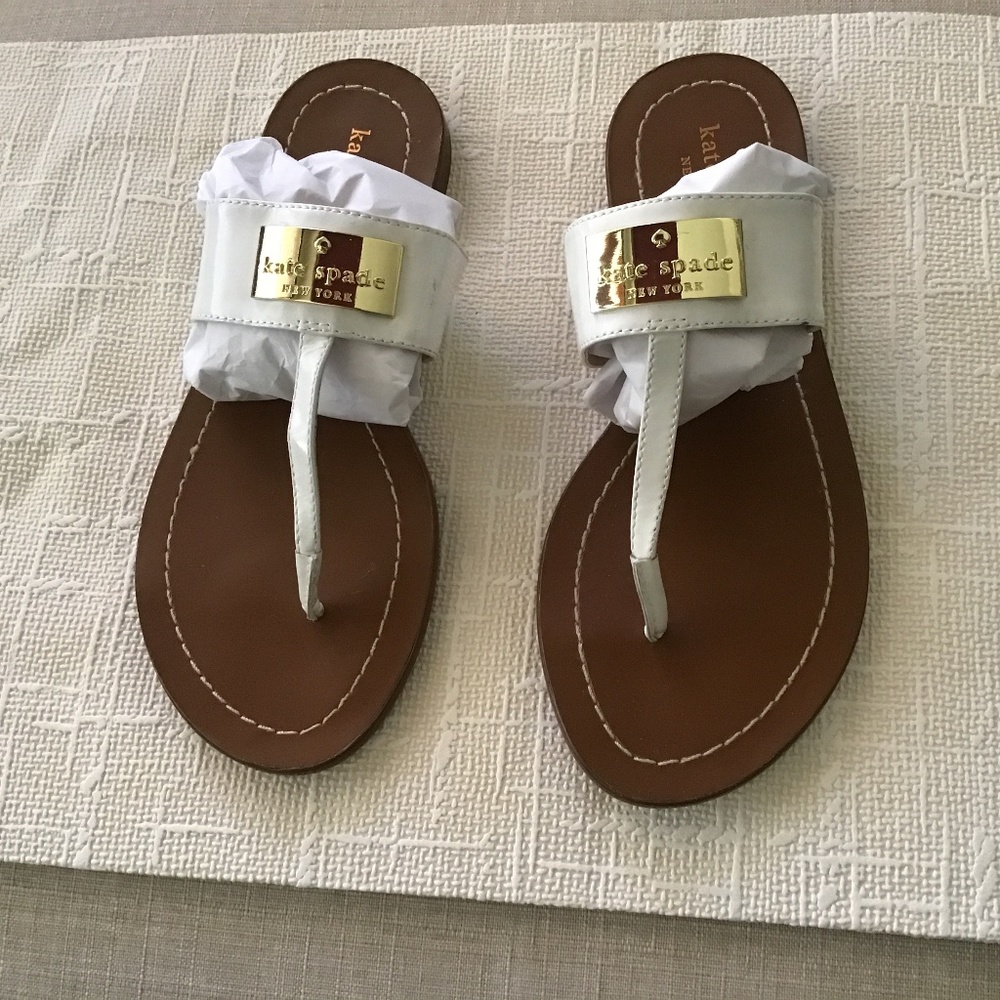 Kate Spade white sandals with gold emblem